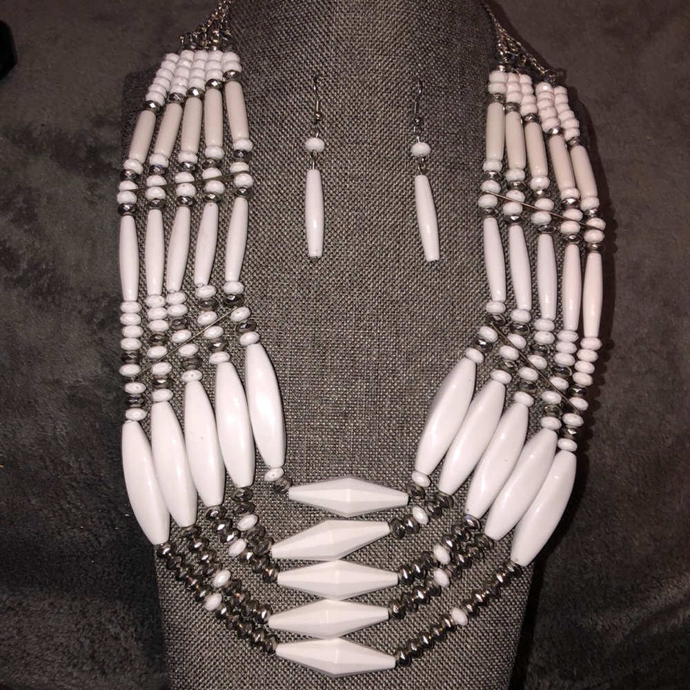 Bicone and molded white beads on silvertone chain. With matching earrings